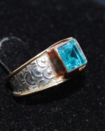 Unusual silver and copper ring with pattern on band and aquamarine stone.